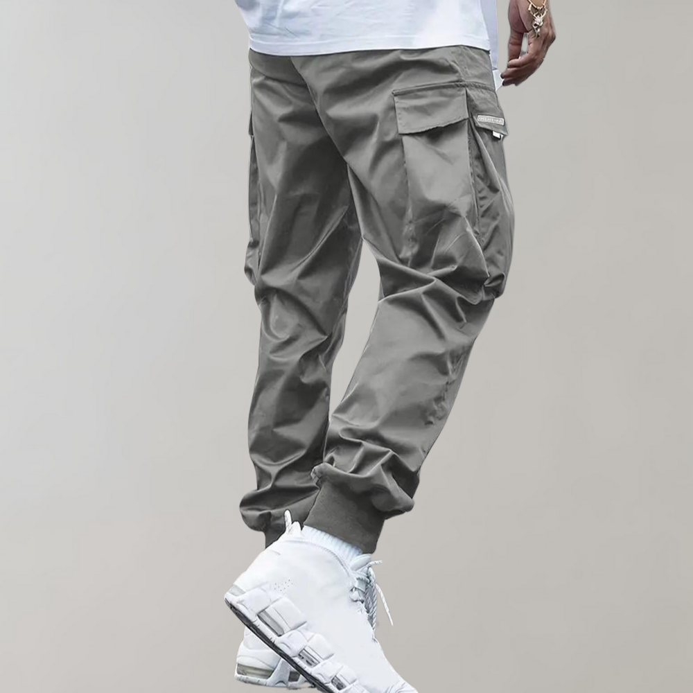 Nael Berlin | Herren Cargo Jogginghose – Lila Streetwear-Hose mit Reißverschlusstaschen & Bündchen